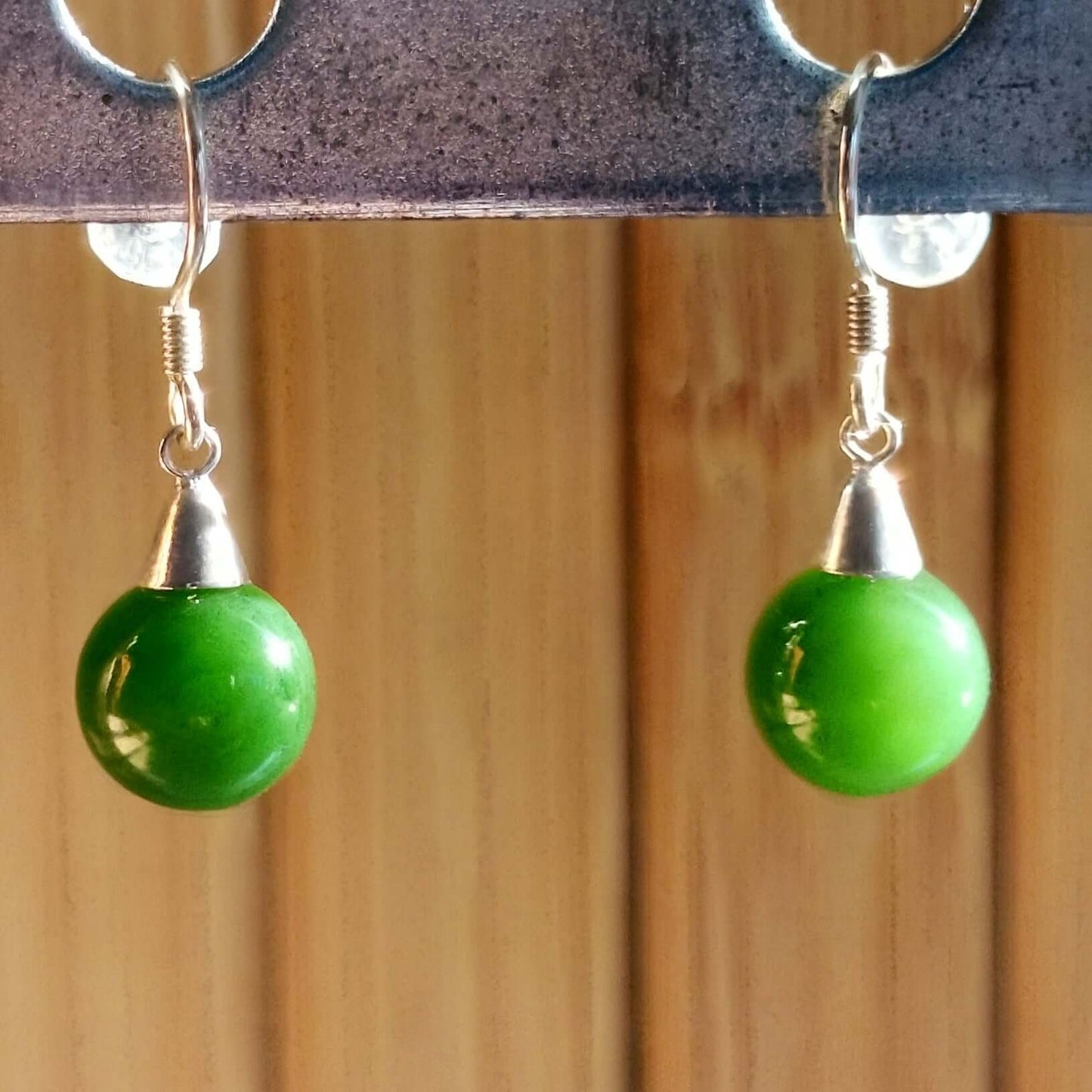 Green Grade A BC jade beaded sterling silver earrings showcasing polished green beads and sleek silver fittings.