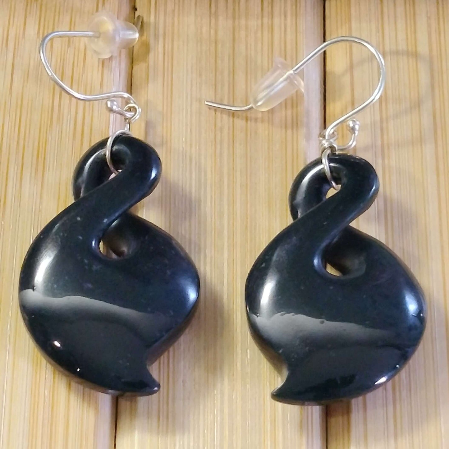 Stylish black jade drop earrings with sterling silver hooks, showcasing modern elegance.
