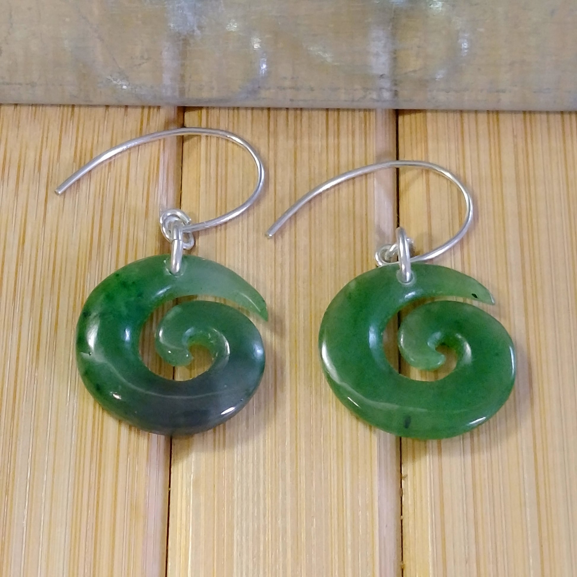 Jade Green Spiral Earrings with silver hooks, featuring a smooth spiral design that exudes elegance.